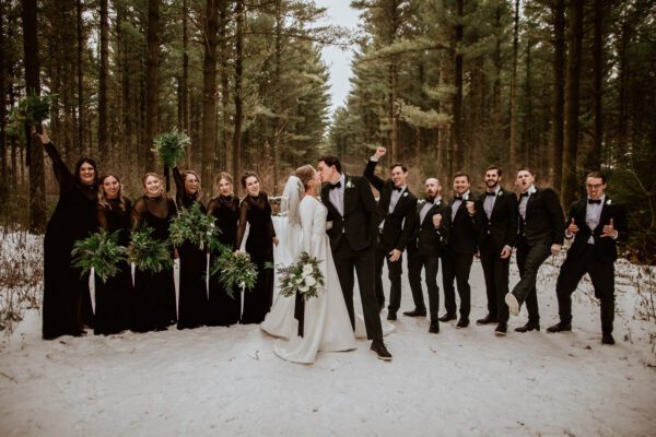 Winter wedding in the pines, with bridesmaids in black velvet, greenery bouquets, classic white bouquet.